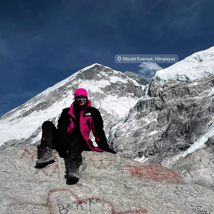 Olga Pabjan at base camp below Mount Everest in the Himalayas, against a snow-capped peak